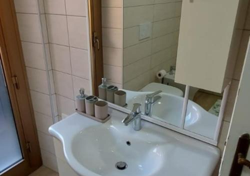a bathroom with a white sink and a mirror at Casa Elena in Ventimiglia
