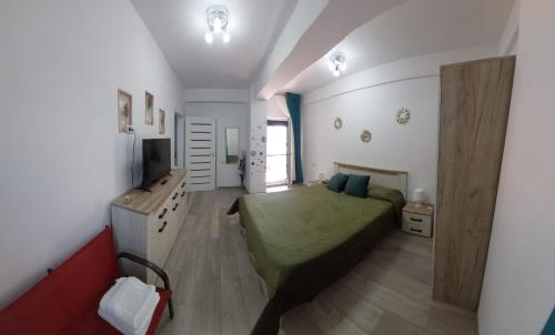 a bedroom with a bed and a television in it at Apart Alex in Constanţa