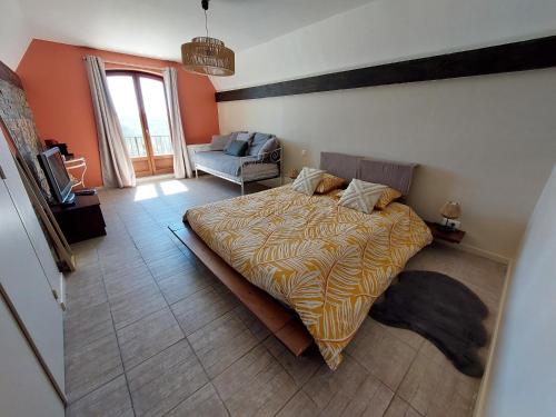 a bedroom with a bed and a chair in it at Le Cocon Des Roches in Cessieu