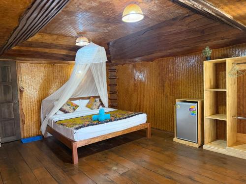 a bedroom with a bed with a canopy at Activities Resort in Ko Yao Yai
