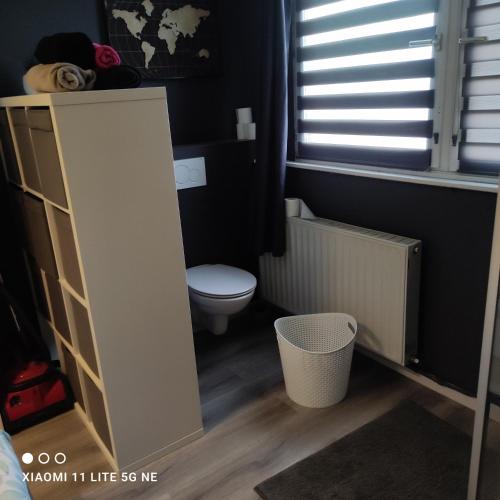 a small bathroom with a toilet and a window at Escale in Liège