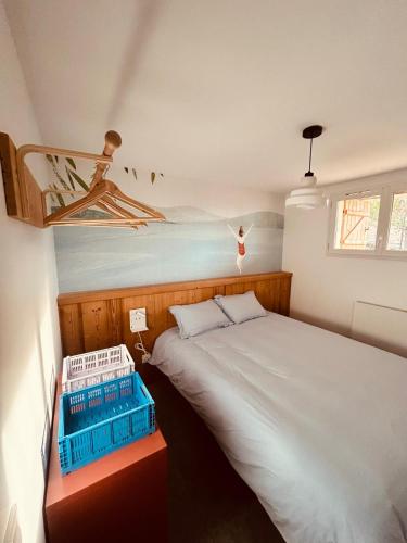 a bedroom with a bed with a painting on the wall at La Parenthèse du Léman in Évian-les-Bains