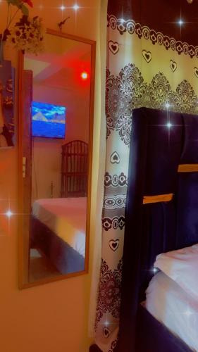 a mirror in a room with a bed and a bedroom at Leisure guest in Diani Beach