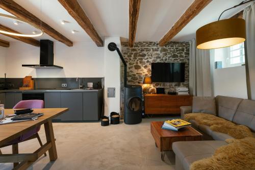 a living room with a couch and a table at Chalet Weidehaus De Luxe in Obertriesting