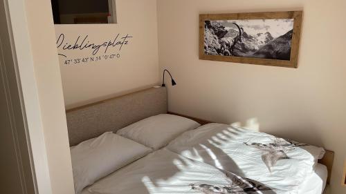 a bed in a room with a sign on the wall at Tauplitzrausch Lodge in Tauplitz