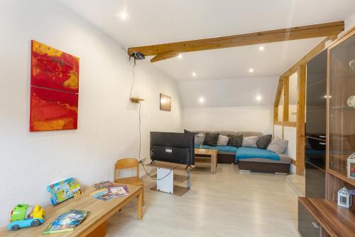 a living room with a couch and a tv at Ferienwohnung Sonnenblume in Rhadern