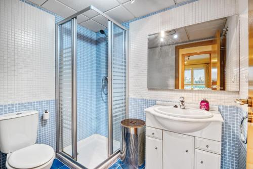 a bathroom with a shower and a toilet and a sink at Puerto Romano in Denia