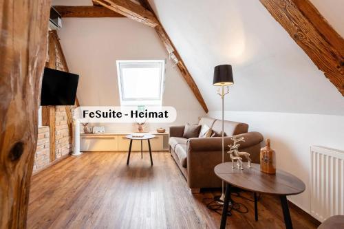 a living room with a couch and a table at Boutique Suites anno 1789 by Kamelu in Gengenbach