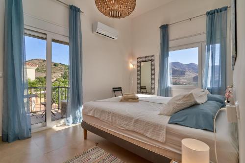 a bedroom with a bed and a large window at Casa Palmeras in Almuñécar