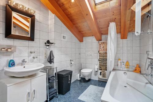 a bathroom with a sink and a tub and a toilet at Place In The Bavarian Mountains in Schneizlreuth