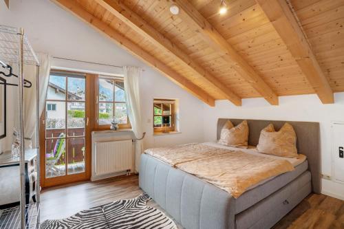 a bedroom with a bed with a wooden ceiling at Place In The Bavarian Mountains in Schneizlreuth