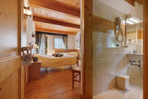 a bathroom with a shower and a bedroom with a bed at Agritur Maso Pan in Caderzone Terme