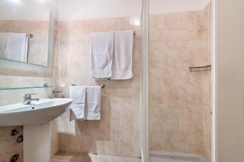 a bathroom with a sink and a shower at Nice apartment Le Vele Garda Lake in Toscolano Maderno