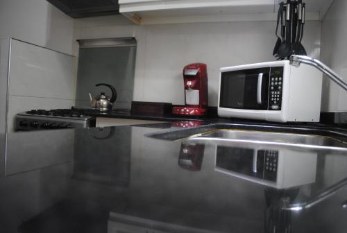 
a microwave oven sitting on top of a counter top at First Class Apartments in Córdoba
