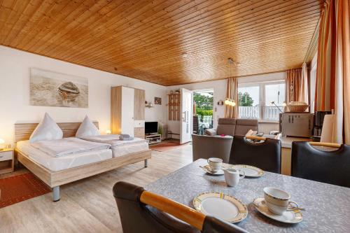 a living room with a bed and a dining room at Ferienhaus Landhaus Loose in Schashagen