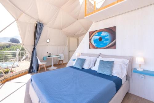 a bedroom in a dome house with a bed at Dome on the hill with Jacuzzi in Castellammare del Golfo
