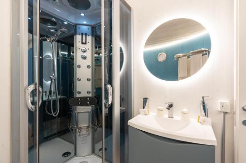 a bathroom with a shower and a sink and a mirror at Dome on the hill with Jacuzzi in Castellammare del Golfo