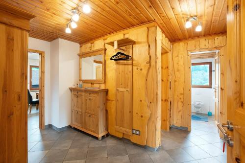 a kitchen with wooden walls and a wooden ceiling at Wohnung Kuhblick in Baiersbronn