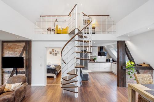 a spiral staircase in a living room with a bedroom at Ferienwohnung Oertzheide in Hermannsburg