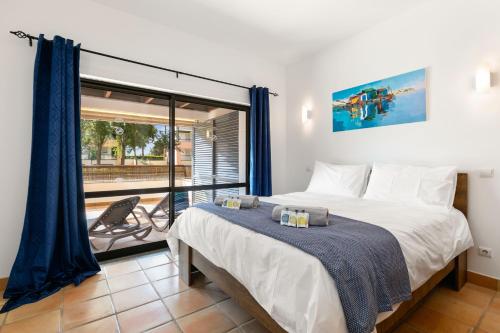 a bedroom with a large bed and a balcony at Marina park Apartment in Lagos