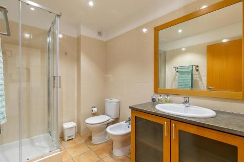a bathroom with a toilet and a sink and a shower at Marina park Apartment in Lagos