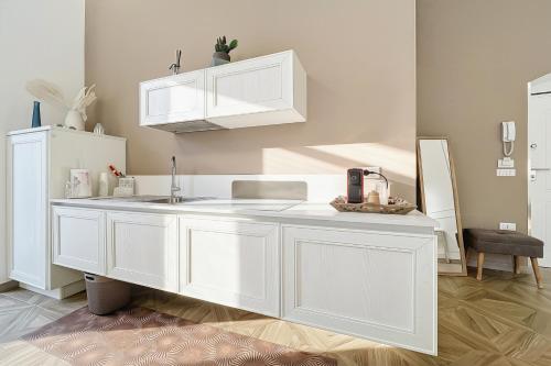 a kitchen with white cabinets and a sink at Orchidea Celeste Bed and Breakfast in Manfredonia