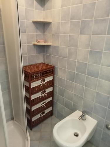 a bathroom with a sink and a toilet and a shower at Casetta Esmeralda in Praia a Mare