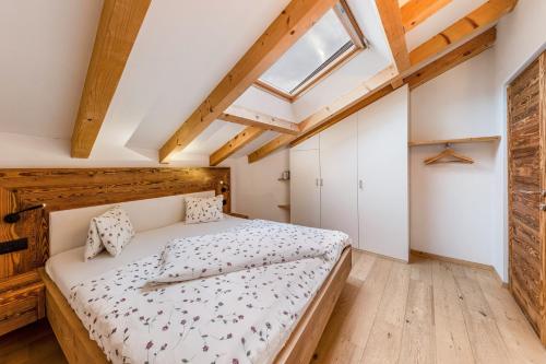 a bedroom with a bed and a skylight at Naturoase Stegerhof Apt Margerite in Trodena