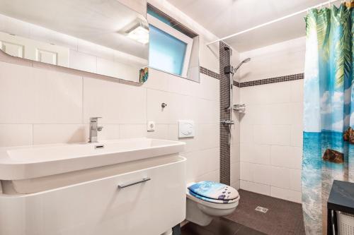 a bathroom with a sink and a toilet at Bungalow Passat - Bgl 5 in Dranske