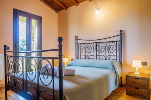 a bedroom with a bed and a window at Vento di Maremma in Marina di Grosseto