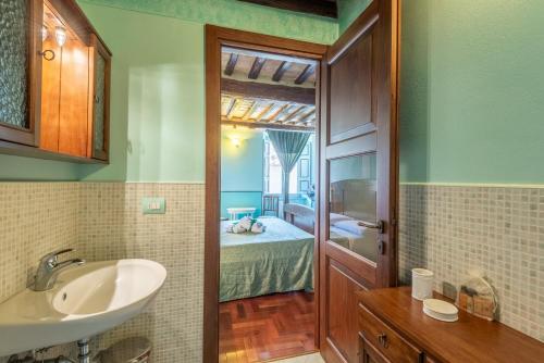 a bathroom with a sink and a bathroom with a bedroom at beb del Musico in Montalcino