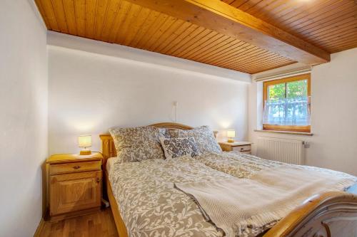 a bedroom with a bed and two lamps on night stands at Haus Maria in Laufen
