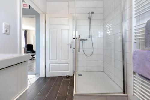 a bathroom with a shower with a glass door at Alte Schule Schalkholz in Schalkholz