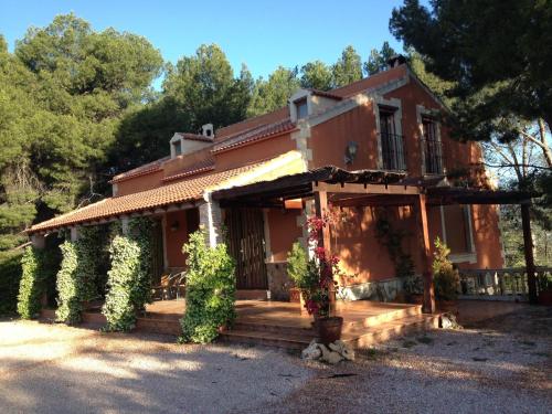 a house with flowers in front of it at El Pinar de la Loma in Moratalla