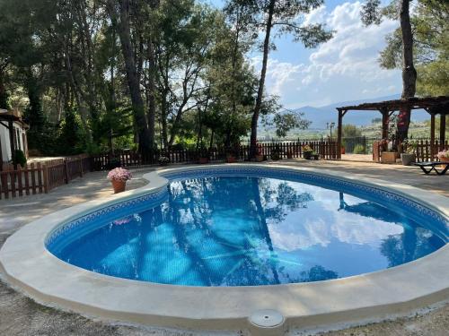 a swimming pool in a yard with a gazebo at El Pinar de la Loma in Moratalla