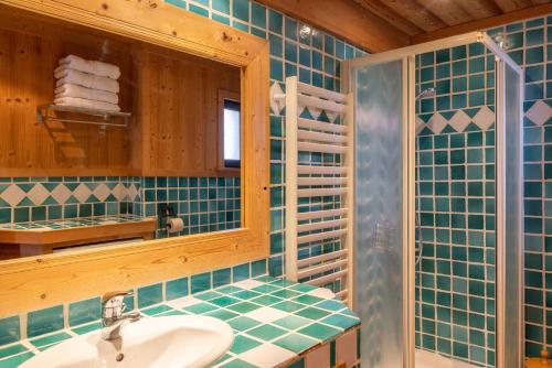 a bathroom with a sink and a mirror at Appartement les 4 As in Megève