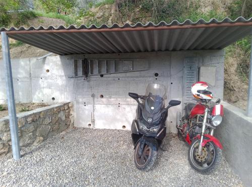 a motorcycle parked under a building next to a wall at Magnifique roulotte in Sospel