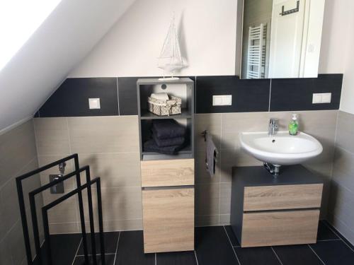 a bathroom with a sink and a mirror at Ferienhaus Melody in Ralswiek