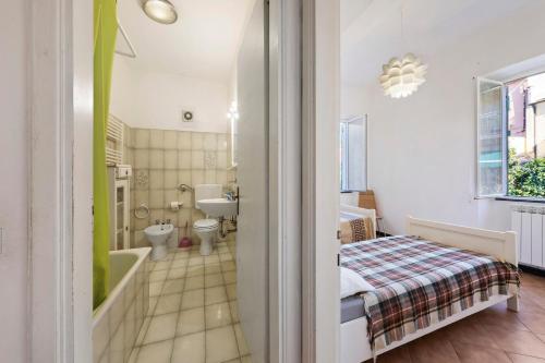 a bathroom with a tub and a toilet and a sink at Casa Federico in Levanto