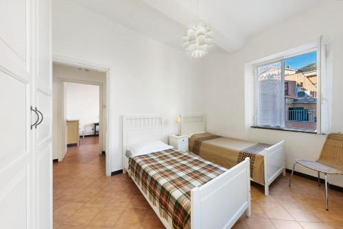 a bedroom with two beds and a window at Casa Federico in Levanto
