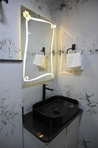 a bathroom with a black sink and a mirror at Crystal Water in Mulshi