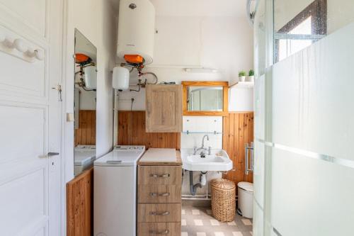 a small bathroom with a sink and a toilet at Chalet des Bruyères in Saint-Jorioz