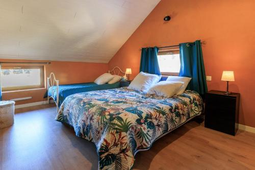 a bedroom with a bed with blue curtains at Cuicui les p'tits oiseaux in Lesperon