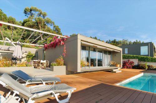 a house with a swimming pool and a deck at Casa da Quinta dos Moinhos in Seixas