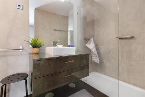 a bathroom with a sink and a glass shower at Casa da Quinta dos Moinhos in Seixas