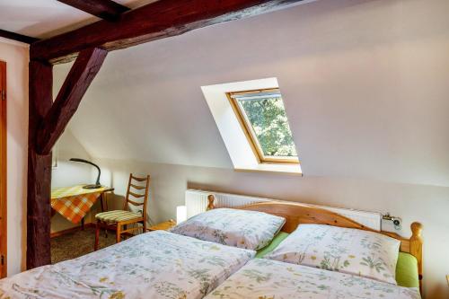 a bedroom with a bed and a window and a desk at Fachwerkferienhaus in Ulrichshusen