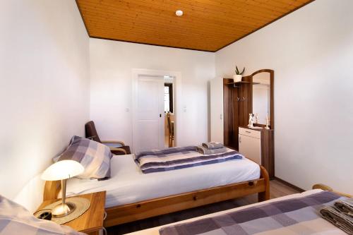 a bedroom with a bed and a table and a mirror at Kastanienallee 43 in Ilsenburg
