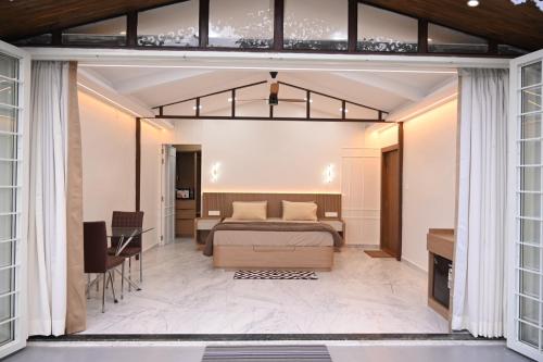 a bedroom with a bed and a desk at Crystal Water in Mulshi