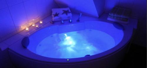 a bathroom with a large tub with a purple lighting at Villa Sorgenfrei in Zinnowitz