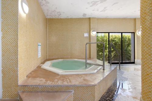 a bathroom with a hot tub in a room at Casa Diouma in Cabanas de Tavira